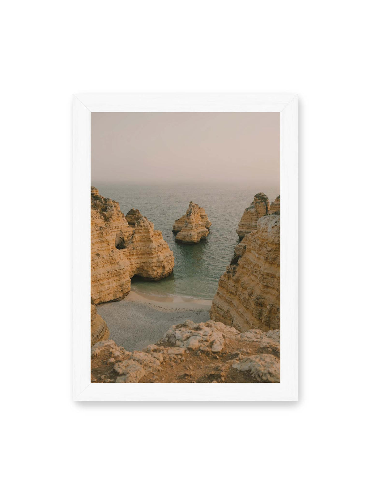 21x30 cm, weißer Rahmen – Schichtartige Felsformationen umgeben eine kleine Bucht mit ruhigem Wasser und schmalem Sandstrand.