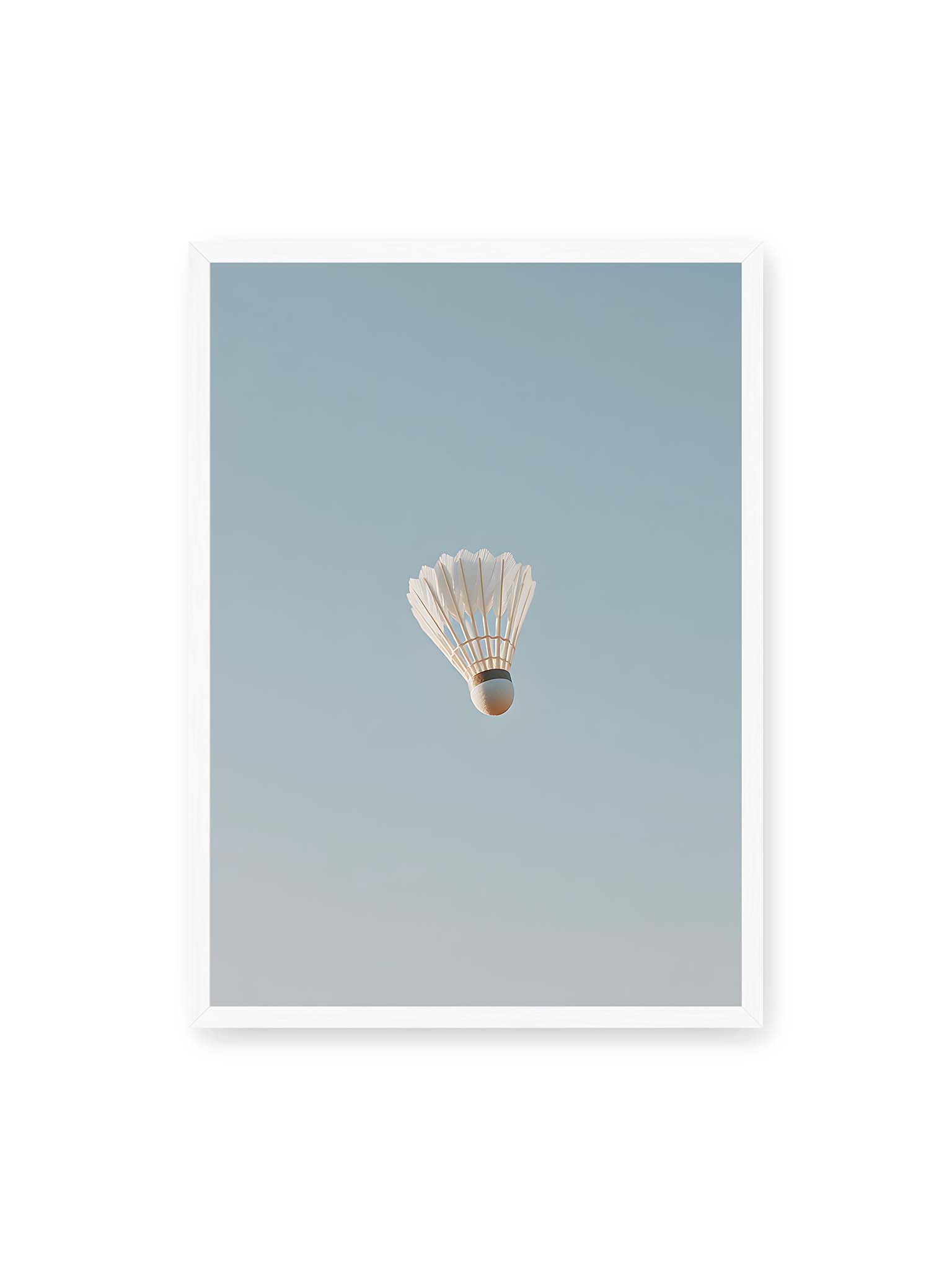 50x70 cm, weißer Rahmen – Weißer Federball schwebt zentriert vor hellblauem Himmel, minimalistische Komposition mit viel Freiraum.