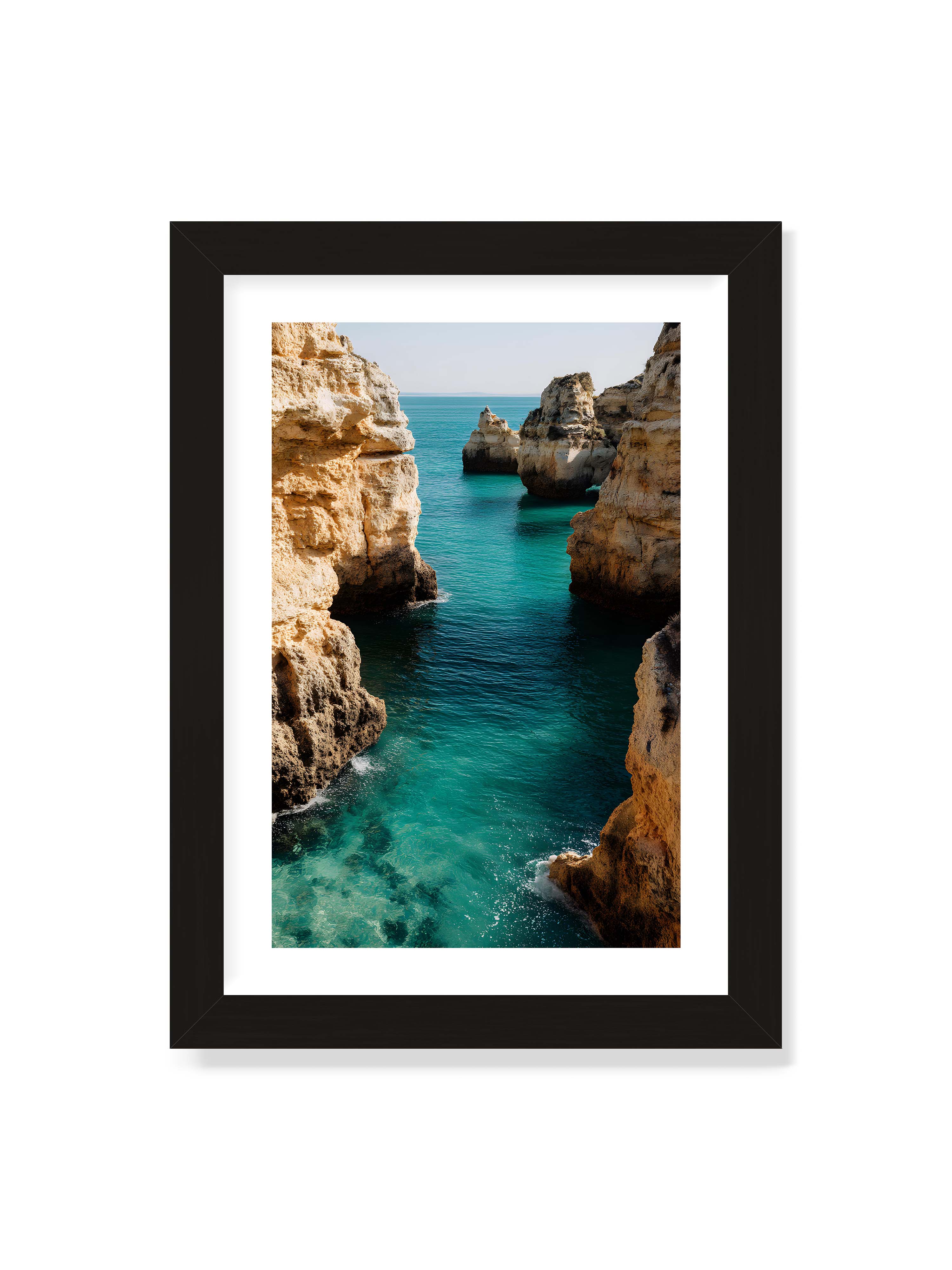 21x30 cm mit weißem Galerie-Rand mit schwarzem Rahmen – Felsen an einer Küste, umgeben von klarem, türkisfarbenem Wasser, das sanft an die Klippen schwappt.