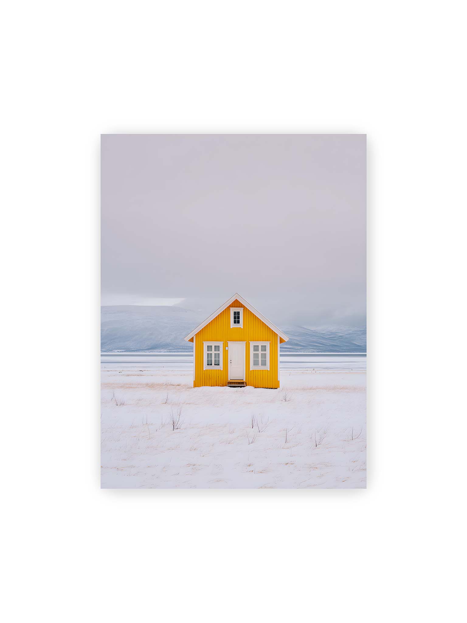 30x40 cm – Gelbes Haus steht allein in weiter verschneiter Landschaft mit Bergen im Hintergrund und grauem Himmel.