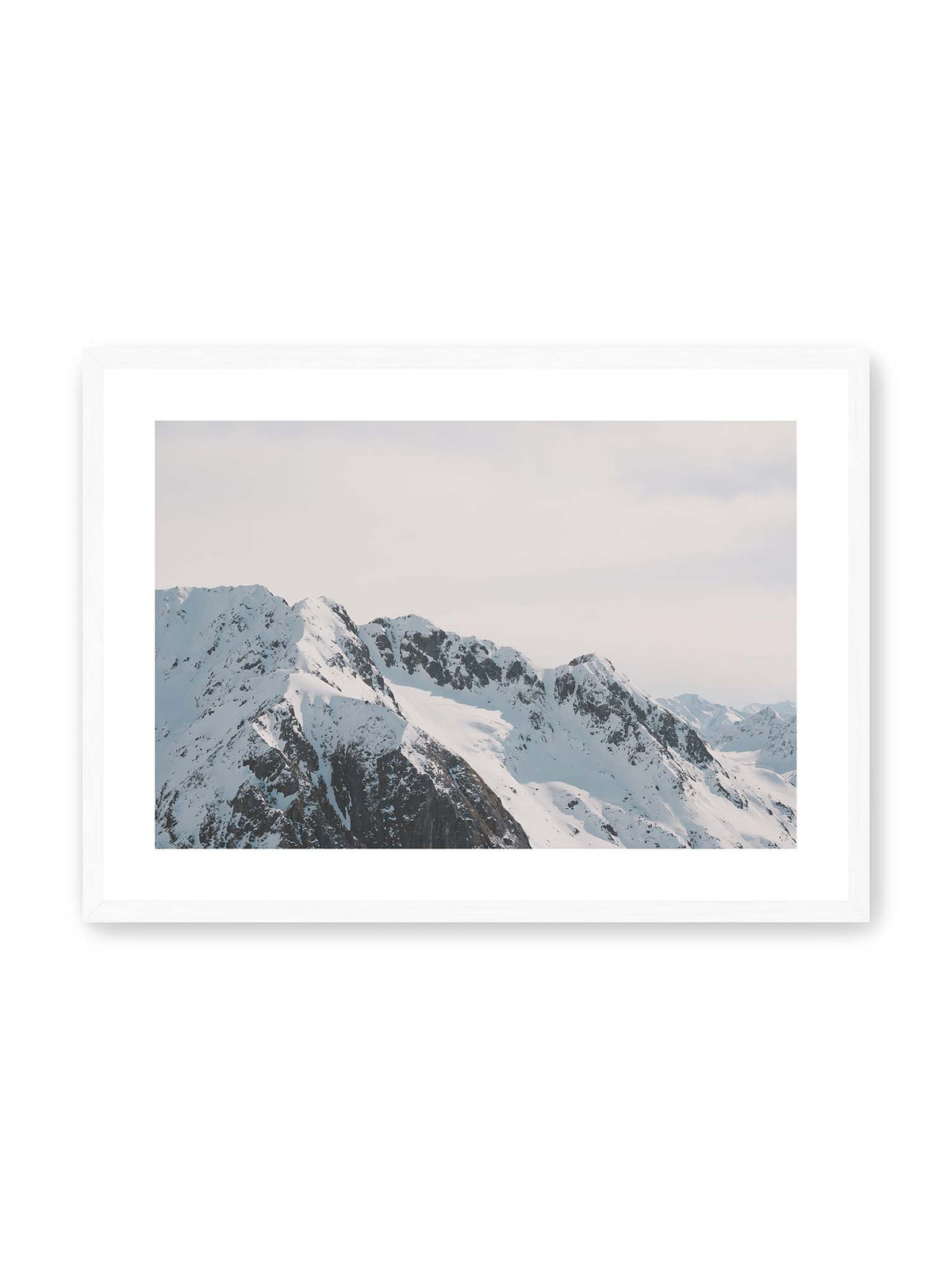 70x50 cm, weißer Galerie-Rand, weißer Rahmen – Verschneite Bergkette mit schroffen Felswänden und gestaffelten Gipfeln unter einem hellen, weiten Himmel.