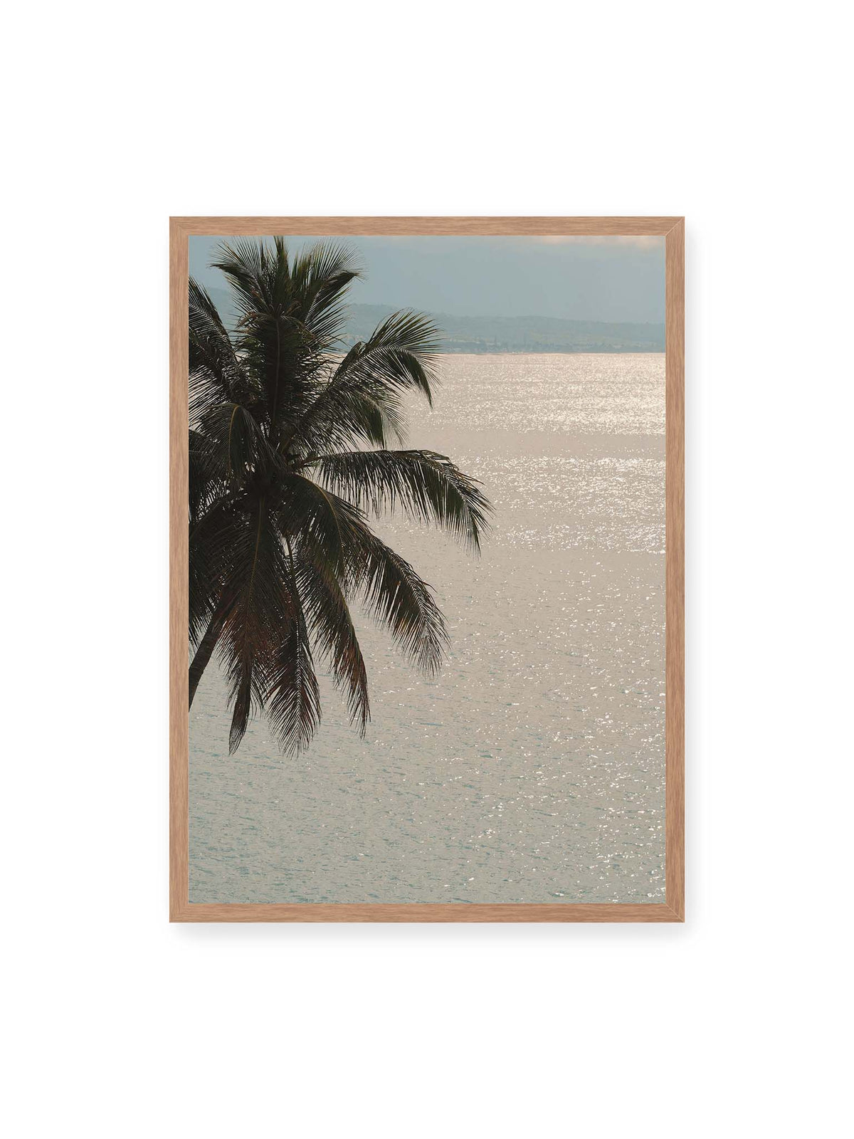 50x70 cm, Eichenrahmen – Dunkle Palmwedel vor einer hell glitzernden Wasserfläche mit einer fernen Küstenlinie.