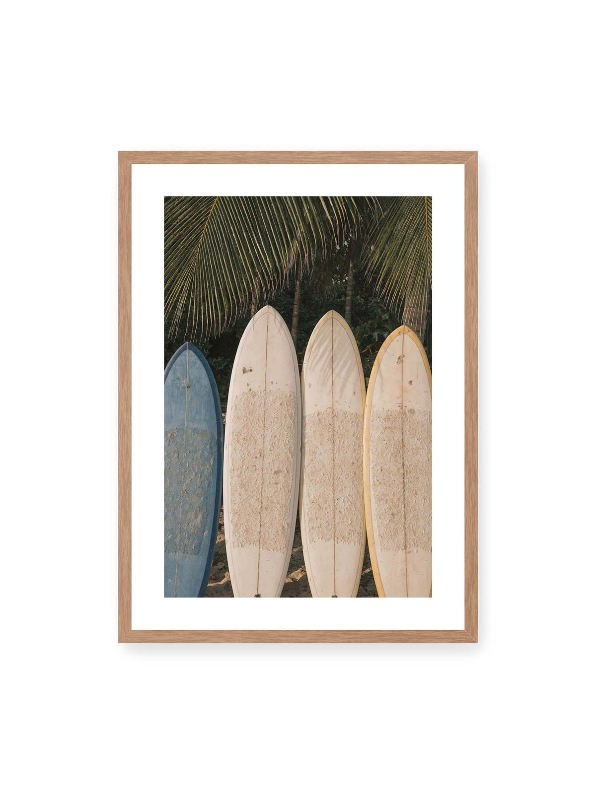 50x70 cm, weißer Galerie-Rand, Eichenrahmen – Vier aufrecht stehende Surfbretter mit Wachsresten unter langen Palmwedeln vor dichter grüner Vegetation.
